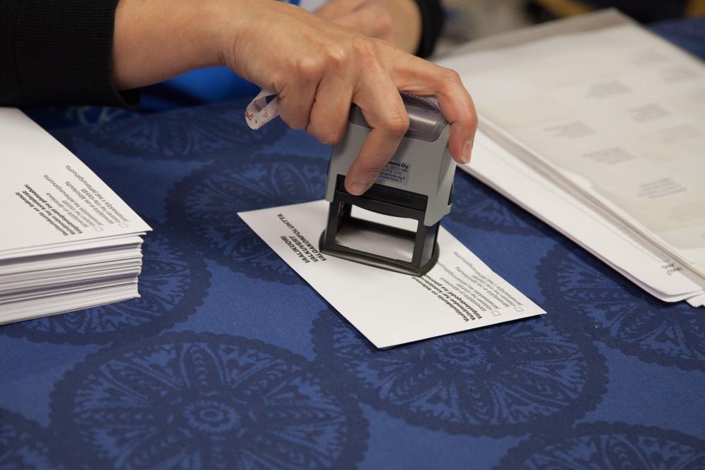 An election envelope being stamped. 