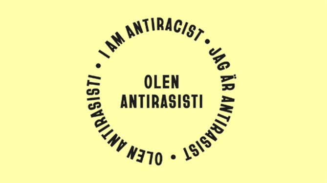 Texten I am antiracist - Jag är antirasist - Olen antirasisti bildar en cirkel mot gul bakgrund. I cirkel står Olen antirasisti.