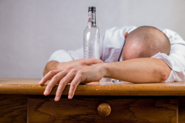 Man with a bottle of alcohol.
