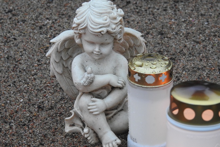 An angel statue and two candles