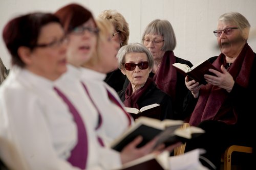 Pastors and old people singing at church service.