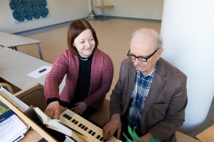 Sjukhuspräst och äldre man som spelar piano