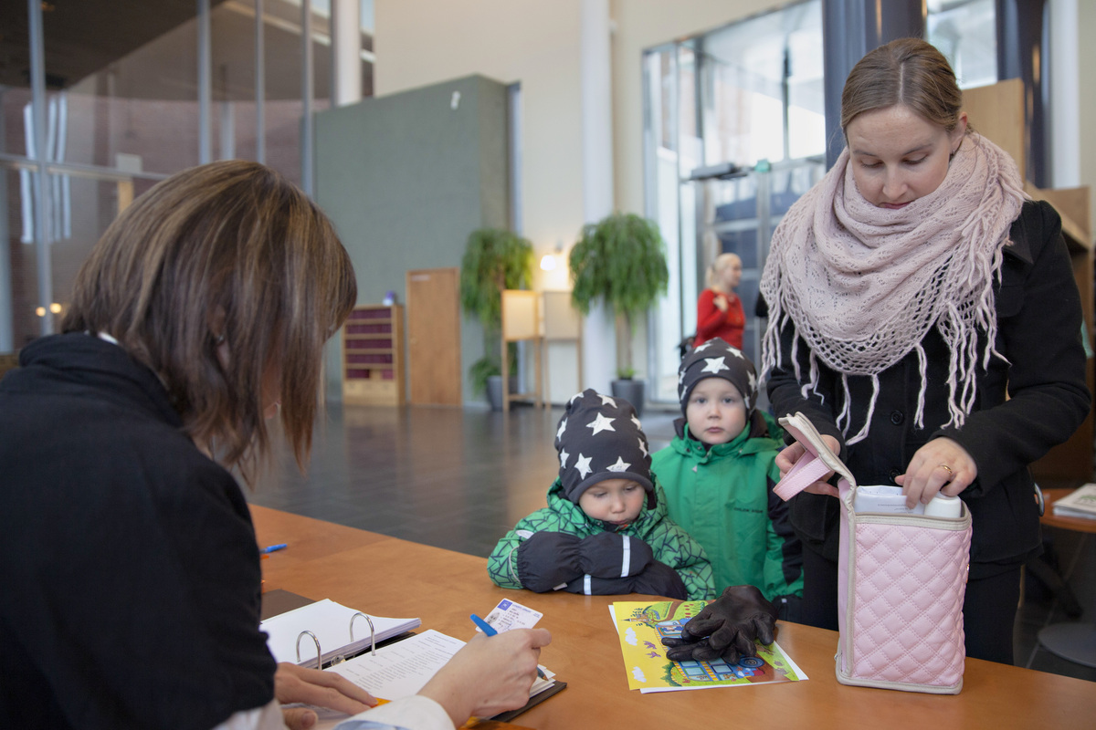 A woman with children at the church office.