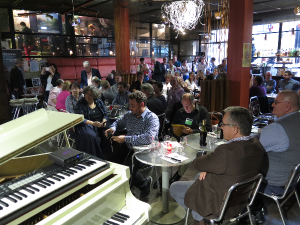 People sitting in a restaurant and listening the speech.