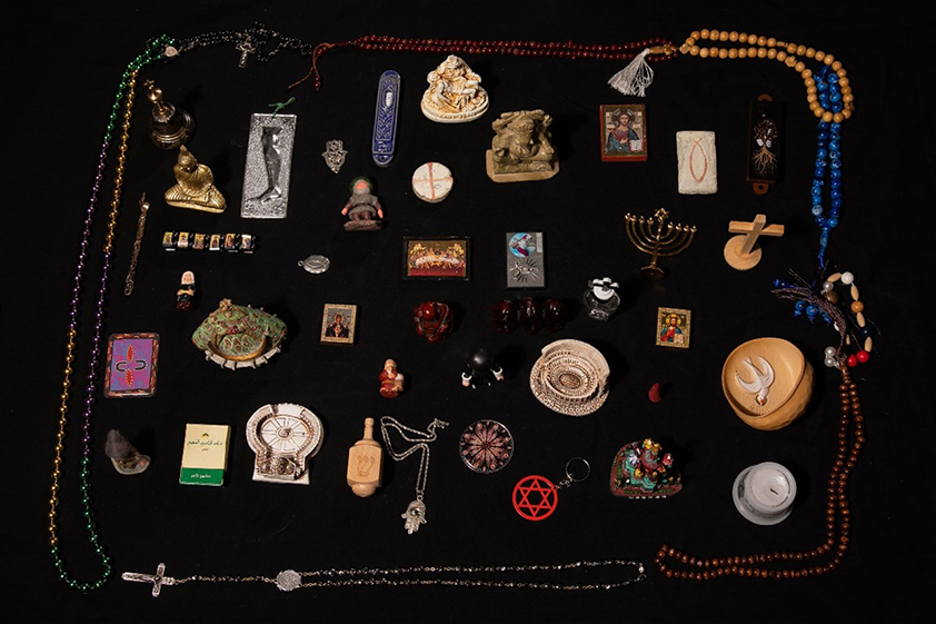 Eri uskontojen symboleita pöydällä.
